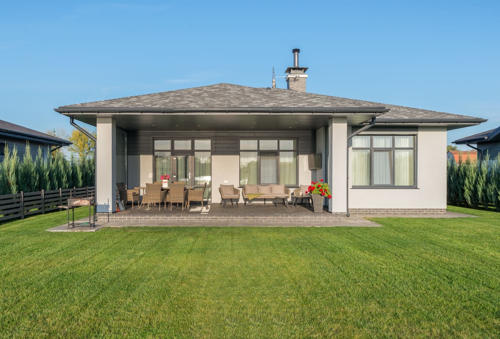 Manicured backyard lawn behind a patio home